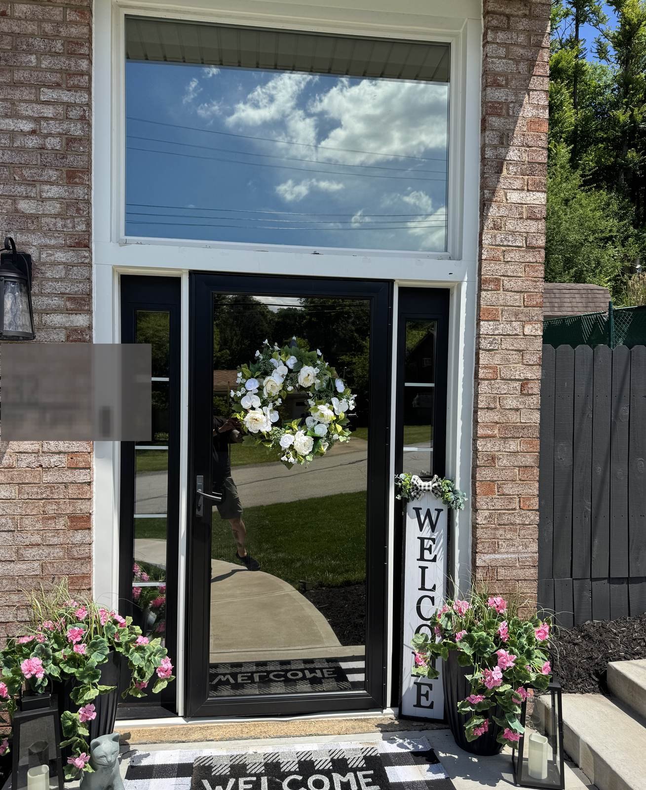 Front door with reflective solar privacy film on glass
